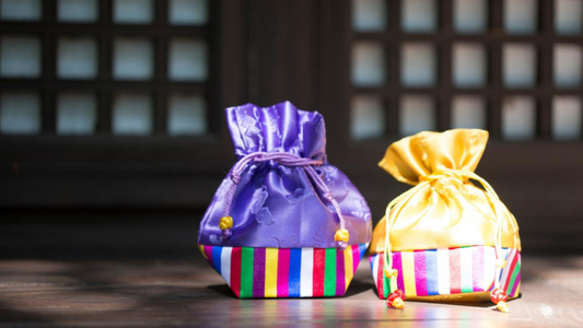 Two colorful traditional Korean gift pouches, or bokjumeoni, placed side by side